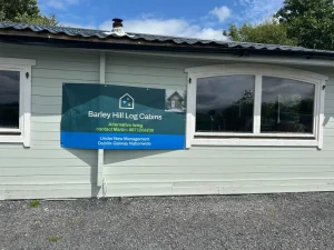 Log home with Barley Hill banner on front, built in Ireland